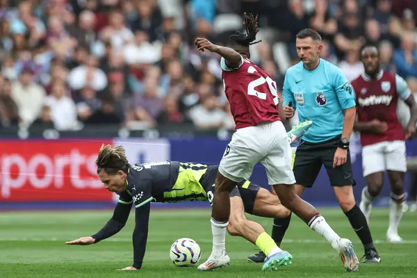 stock image Jack Grealish of Manchester City is fouled by Aaron Wan-Bissaka of West Ham United during the Premier League match West Ham United vs Manchester City at London Stadium, London, United Kingdom, 31st August 2024