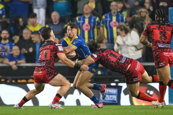 stock image Matty Ashton of Warrington Wolves is tackled by Gareth OBrien of Leigh Leopards and Kai ODonnell of Leigh Leopards during the Betfred Super League Round 24 match Leigh Leopards vs Warrington Wolves at Leigh Sports Village, Leigh, United Kingdom