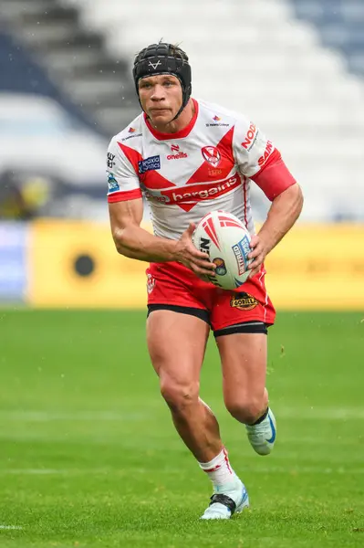 stock image Jonny Lomax of St. Helens makes a break during the Betfred Super League Round 24 match Huddersfield Giants vs St Helens at John Smith's Stadium, Huddersfield, United Kingdom, 1st September 2024