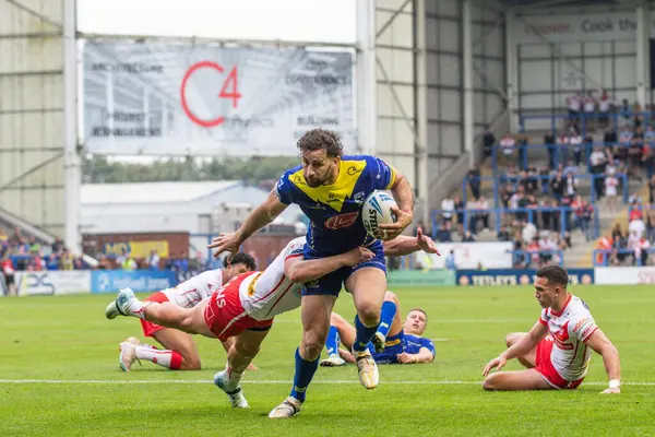 stock image Toby King of Warrington Wolves is tackled just before the try line during the Betfred Super League Round 25 match Warrington Wolves vs St Helens at Halliwell Jones Stadium, Warrington, United Kingdom, 7th September 2024