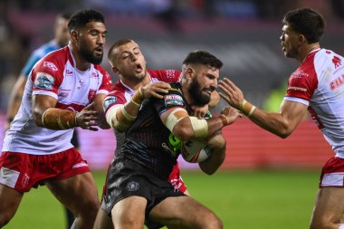 Abbas Miski of Wigan Warriors is tackled by Mikey Lewis of Hull KR during the Betfred Super League Round 25 match Wigan Warriors vs Hull KR at The Brick Community Stadium, Wigan, United Kingdom, 6th September 2024 clipart