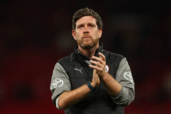 stock image Darrell Clarke Manager of Barnsley applauds the fans at the end of the Carabao Cup 3rd Round match Manchester United vs Barnsley at Old Trafford, Manchester, United Kingdom, 17th September 2024