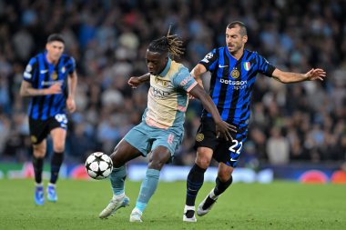 Manchester City 'den Jrmy Doku, UEFA Şampiyonlar Ligi sahne maçı sırasında Inter Milan' dan Henrikh Mkhitaryan 'ı 18 Eylül 2024' te Etihad Stadyumu, Manchester 'da Inter Milan' a karşı durdurdu.