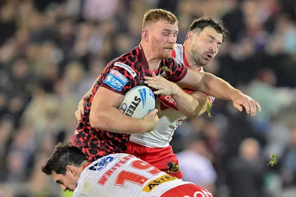 stock image Jack Hughes of Leigh Leopards is tackled by Matt Whitley of St. Helens and Tommy Makinson of St. Helens during the Betfred Super League Round 27 match Leigh Leopards vs St Helens at Leigh Sports Village, Leigh, United Kingdom, 20th September 2024