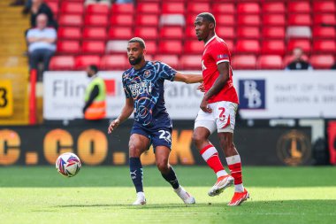 CJ Hamilton of Blackpool is put under pressure by Kayne Ramsay of Charlton Athletic during the Sky Bet League 1 match Charlton Athletic vs Blackpool at The Valley, London, United Kingdom, 21st September 2024 clipart