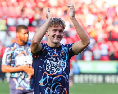 Dom Ballard of Blackpool acknowledges the fans after the teams victory following the Sky Bet League 1 match Charlton Athletic vs Blackpool at The Valley, London, United Kingdom, 21st September 2024 clipart