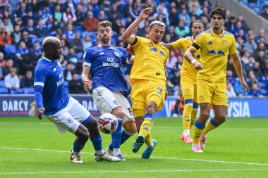 Ethan Ampadu of Leeds United shoots on goal but is blocked by Wilfried Kanga of Cardiff City during the Sky Bet Championship match Cardiff City vs Leeds United at Cardiff City Stadium, Cardiff, United Kingdom, 21st September 2024 clipart