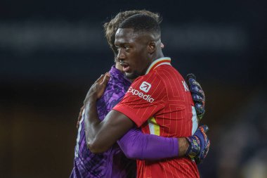 Alisson Becker of Liverpool embraces Ibrahima Konat of Liverpool after the game during the Premier League match Wolverhampton Wanderers vs Liverpool at Molineux, Wolverhampton, United Kingdom, 28th September 2024 clipart