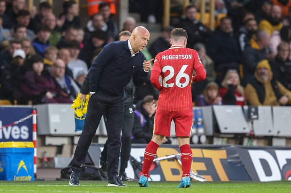 Arne Slot manager of Liverpool gives Andrew Robertson of Liverpool instructions during a break in play during the Premier League match Wolverhampton Wanderers vs Liverpool at Molineux, Wolverhampton, United Kingdom, 28th September 2024