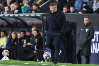Plymouth Argyle 'ın Wayne Rooney teknik direktörü, 1 Ekim 2024' te Burnley-Plymouth Argyle maçında oyundan çıkarken topa vuruyor.