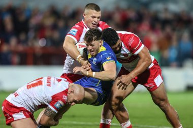 Matty Ashton of Warrington Wolves is tackled by Dean Hadley of Hull KR during the Betfred Super League Semi-Finals match Hull KR vs Warrington Wolves at Sewell Group Craven Park, Kingston upon Hull, United Kingdom, 4th October 2024 clipart