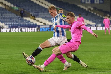 Lasse Srensen of Huddersfield Town and Georgie Gent of Barnsley battle for the ball during the Bristol Street Motors Trophy match Huddersfield Town vs Barnsley at John Smith's Stadium, Huddersfield, United Kingdom, 8th October 2024 clipart