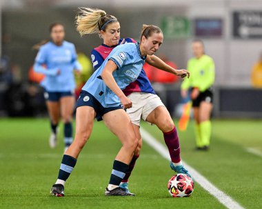 Alexia Putellas battles for the ball with Naomi Layzell of Manchester City Women during the UEFA Women's Champions League match  - Group D - Manchester City vs Barcelona at Manchester City Academy Stadium, Manchester, United Kingdom, 9th October 2024 clipart