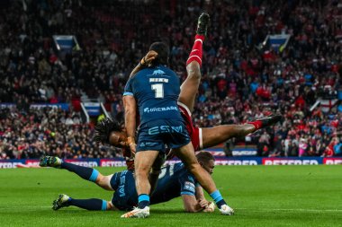 Junior Nsemba of Wigan Warriors is tackled by James Batchelor and Peta Hiku of Hull KR during the Betfred Super League Grand Final match Wigan Warriors vs Hull KR at Old Trafford, Manchester, United Kingdom, 12th October 2024 clipart