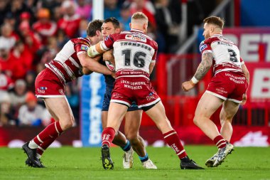 Ryan Hall of Hull KR is tackled by Ethan Havard and Luke Thompson of Wigan Warriors during the Betfred Super League Grand Final match Wigan Warriors vs Hull KR at Old Trafford, Manchester, United Kingdom, 12th October 2024 clipart