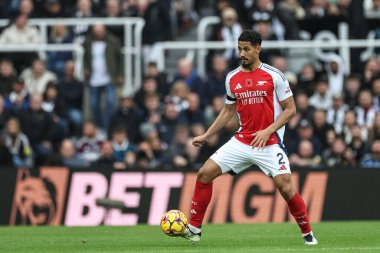 William Saliba of Arsenal with the ball during the Premier League match Newcastle United vs Arsenal at St. James's Park, Newcastle, United Kingdom, 2nd November 2024 clipart