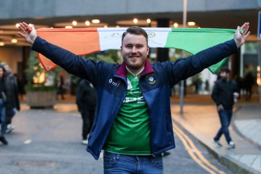 A Ireland fan drapes his countys flag behind his back during the UEFA Nations League, League B - Group 2 match England vs Republic of Ireland at Wembley Stadium, London, United Kingdom, 17th November 2024 clipart