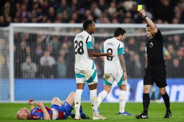 Joe Willock of Newcastle United is shown a yellow card by referee Darren England during the Premier League match Crystal Palace vs Newcastle United at Selhurst Park, London, United Kingdom, 30th November 2024 clipart