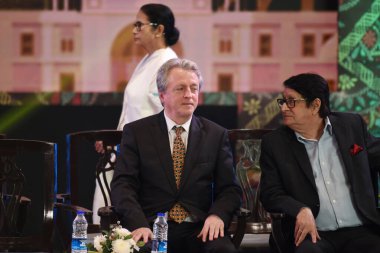 Argentina Film Maker Pablo Justino Cesar with Indian Actor Ranjit Mallick and backside Chief Minister of West Bengal state Mamata Banerjee during the inauguration of the 30th Kolkata International Film Festival in Kolkata, India  clipart