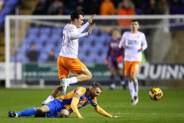 Kyle Joseph of Blackpool is tackled during the Sky Bet League 1 match Shrewsbury Town vs Blackpool at Croud Meadow, Shrewsbury, United Kingdom, 4th December 2024 clipart