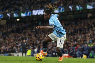 Jrmy Doku of Manchester City breaks with the ball during the Premier League match Manchester City vs Nottingham Forest at Etihad Stadium, Manchester, United Kingdom, 4th December 2024 clipart