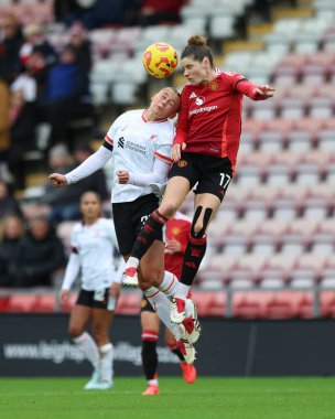 Dominique Janssen and Teagan Micah jump up high to head the ball during the Barclays Women's Super League match Manchester United Women vs Liverpool Women at Leigh Sports Village, Leigh, United Kingdom, 8th December 2024 clipart