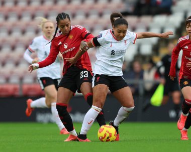 Taylor Hinds of Liverpool is tackled by Geyse of Manchester United during the Barclays Women's Super League match Manchester United Women vs Liverpool Women at Leigh Sports Village, Leigh, United Kingdom, 8th December 2024 clipart