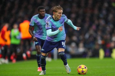 Martin degaard of Arsenal makes a break with the ball during the Premier League match Fulham vs Arsenal at Craven Cottage, London, United Kingdom, 8th December 2024 clipart