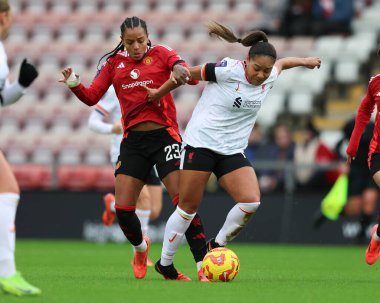 Taylor Hinds of Liverpool is tackled by Geyse of Manchester United during the Barclays Women's Super League match Manchester United Women vs Liverpool Women at Leigh Sports Village, Leigh, United Kingdom, 8th December 2024 clipart