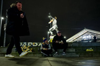 Leeds fans grab a bite to eat at the Billy Bremner Statue during the Sky Bet Championship match Leeds United vs Middlesbrough at Elland Road, Leeds, United Kingdom, 10th December 2024 clipart