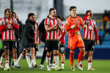 Sheffield United acknowledges the fans after the teams victory following the Sky Bet Championship match Millwall vs Sheffield United at The Den, London, United Kingdom, 11th December 2024 clipart