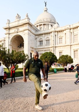 English football manager and former player Sol Campbell  with a football outside the heritage landmark Victoria Memorial in Kolkata, India on December 12,2024  clipart