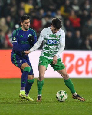 Rory Holden of The New Saints F.C. holds off Dimitris Limnios of Panathinaikos during the UEFA Conference League - League Stage The New Saints v Panathinaikos at Croud Meadow, Shrewsbury, United Kingdom, 12th December 2024 clipart