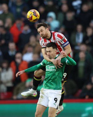 Jack Robinson of Sheffield United jumps up for a header against Ryan Hardie of Plymouth Argyle during the Sky Bet Championship match Sheffield United vs Plymouth Argyle at Bramall Lane, Sheffield, United Kingdom, 14th December 2024 clipart