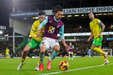 Luca Koleosho of Burnley is put under pressure by Marcelino Nunez of Norwich City during the Sky Bet Championship match Norwich City vs Burnley at Carrow Road, Norwich, United Kingdom, 15th December 2024 clipart