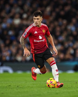 Manchester United takımından Lisandro Martnez, Manchester United ile 15 Aralık 2024 'te Etihad Stadyumu' nda oynanan Premier League maçında topa vuruyor.