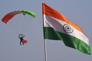 Hindistan ordusundan bir paraşütçü Kolkata, Hindistan 'da 16 Aralık 2024' te yetenek ve sağ tarafta Hindistan Ulusal Bayrağı sergiliyor..