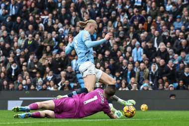 Jordan Pickford of Everton saves the ball from a Erling Haaland of Manchester City challenge during the Premier League match Manchester City vs Everton at Etihad Stadium, Manchester, United Kingdom, 26th December 2024 clipart