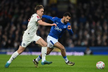 Iliman Ndiaye of Everton goes forward with the ball as he holds off Archie Collins of Peterborough United during the Emirates FA Cup 3rd Round match Everton vs Peterborough United at Goodison Park, Liverpool, United Kingdom, 9th January 2025 clipart