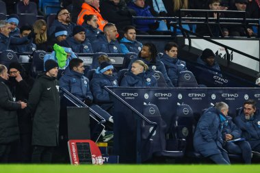 Erling Haaland of Manchester City sits in the dugout during the Emirates FA Cup 3rd Round match Manchester City vs Salford City at Etihad Stadium, Manchester, United Kingdom, 11th January 2025 clipart