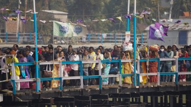 Pilgrims are waiting for their turn to get into the vessel to reach Gangasagar at the Lot number eight jetty ahead of ''Makar Sankranti'' festival at Sagar Island, in the eastern Indian state of West Bengal, on January 12, 2025 clipart