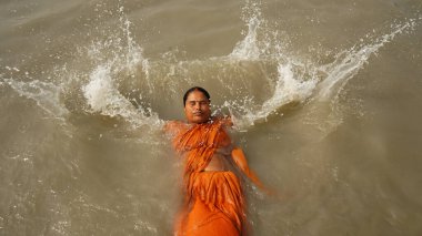  An Indian Hindu pilgrim takes a dip at Gangasagar, some 155 kms south of Kolkata, on January 13, 2025 clipart