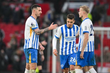 Lewis Dunk celebrates with Jan Paul van Hecke and Yasin Ayari of Brighton & Hove Albion after the final whistle of the Premier League match Manchester United vs Brighton and Hove Albion at Old Trafford, Manchester, United Kingdom, 19th January 2025 clipart