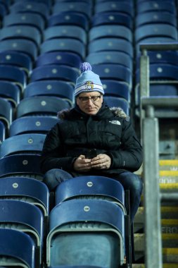 Coventry City taraftarı, 21 Ocak 2025 'te İngiltere' nin Blackburn kentinde Blackburn Park 'ta oynanan Blackburn Rovers-Coventry maçı öncesinde telefonundaki sıralamayı kontrol ediyor.