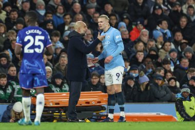 Manchester City 'nin Pep Guardiola teknik direktörü Manchester City' nin Chelsea 'ye karşı oynadığı Premier Lig maçında Manchester City' den Erling Haaland 'a talimat veriyor.