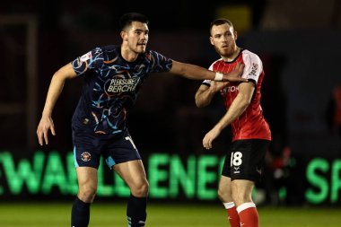 Elkan Baggott of Blackpool holds off Ben House of Lincoln City during the Sky Bet League 1 match Lincoln City vs Blackpool at Gelder Group Sincil Bank Stadium, Lincoln, United Kingdom, 28th January 2025 clipart