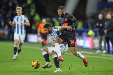 Brodie Spencer Huddersfield Town and Keshi Anderson of Birmingham City battle for the ball during the Sky Bet League 1 match Huddersfield Town vs Birmingham City at John Smith's Stadium, Huddersfield, United Kingdom, 28th January 2025 clipart