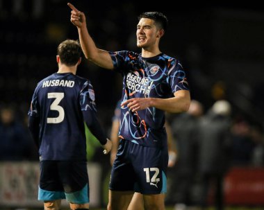 Elkan Baggott of Blackpool celebrates with the fans after the teams victory following the Sky Bet League 1 match Lincoln City vs Blackpool at Gelder Group Sincil Bank Stadium, Lincoln, United Kingdom, 28th January 2025 clipart