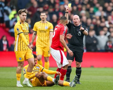 Murillo Santiago of Nottingham Forest receives a yellow card from Referee Simon Hooper during the Premier League match Nottingham Forest vs Brighton and Hove Albion at City Ground, Nottingham, United Kingdom, 1st February 2025 clipart