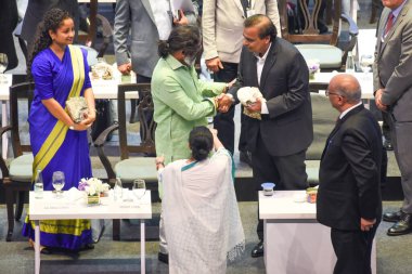 Reliance Industries Chairperson Mukesh Ambani  with Amit Jharkhand Chief Minister Hemant Soren and look West Bengal Chief Minister Mamata Banerjee (White Sharee) during the inaugural session of the Bengal Global Business Summit-2025 clipart